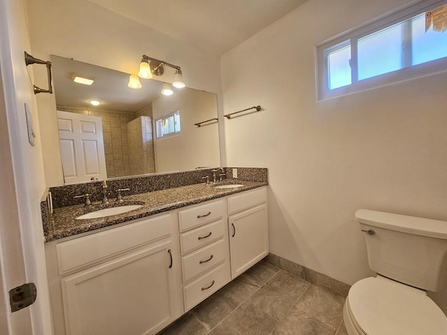 bathroom featuring tile patterned floors, vanity, and toilet