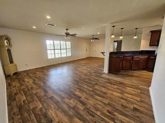 living room featuring ceiling fan and dark wood-type flooring