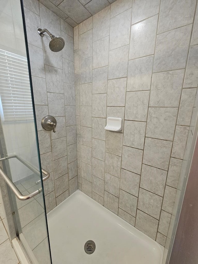 bathroom with a tile shower