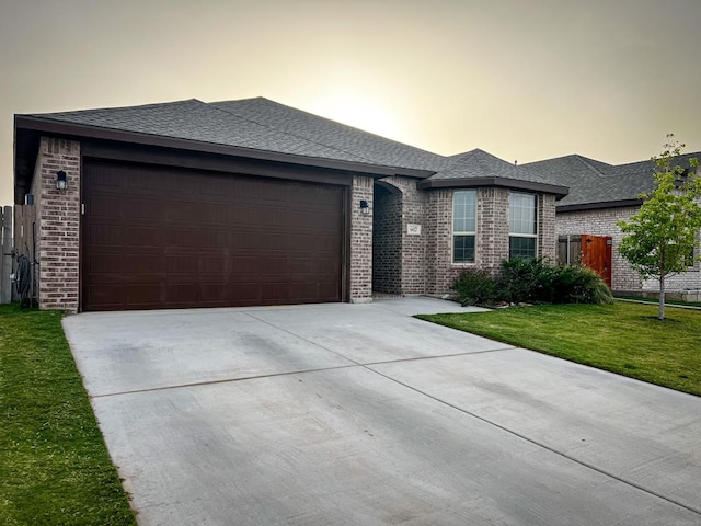 607 Foggy Bottom Ct, Midland, TX 79706 - view of front of property with concrete driveway, a garage, brick siding, and roof with shingles