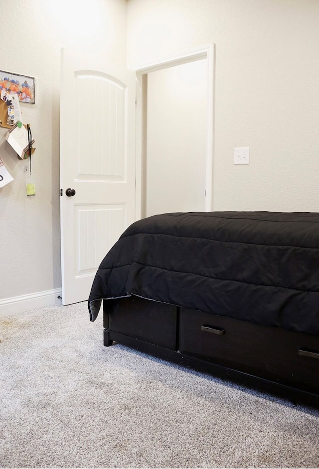 carpeted bedroom with baseboards