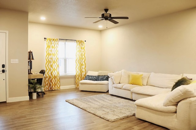 living room with baseboards, a ceiling fan, wood finished floors, a textured ceiling, and recessed lighting