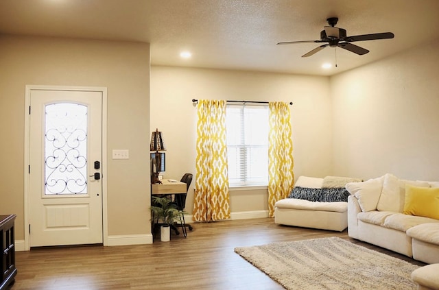 foyer featuring a textured ceiling, ceiling fan, recessed lighting, wood finished floors, and baseboards