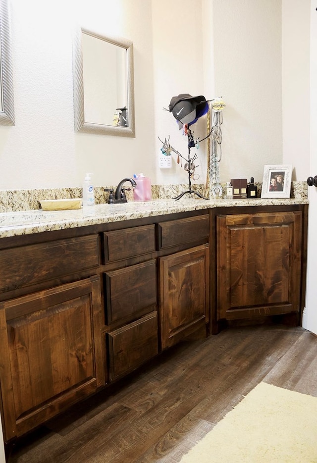 bathroom with vanity and wood finished floors