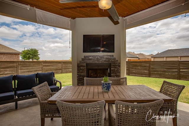 5300 Balfour Ct, Midland, TX 79707 - fenced backyard featuring an outdoor stone fireplace, outdoor dining area, and a patio