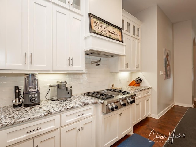 5300 Balfour Ct, Midland, TX 79707 - kitchen featuring stainless steel gas stovetop, glass insert cabinets, decorative backsplash, dark wood finished floors, and white cabinets