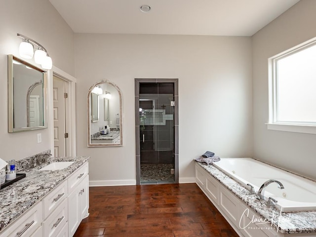 5300 Balfour Ct, Midland, TX 79707 - full bathroom with a shower stall, vanity, a whirlpool tub, and wood finished floors