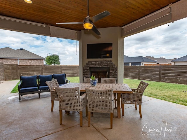 5300 Balfour Ct, Midland, TX 79707 - fenced backyard featuring a patio, a ceiling fan, an outdoor living space with a fireplace, and outdoor dining space