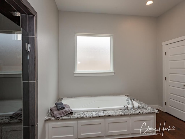 5300 Balfour Ct, Midland, TX 79707 - bathroom with plenty of natural light, a bath, wood finished floors, and recessed lighting