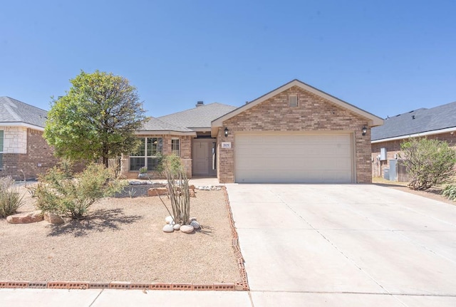 ranch-style house with brick siding, a shingled roof, a garage, and concrete driveway