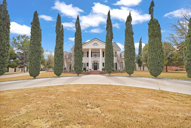 greek revival inspired property with a front lawn