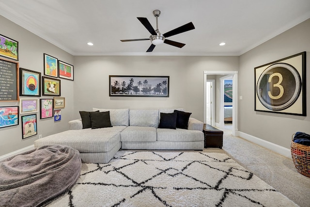 living room with carpet floors, ornamental molding, baseboards, and ceiling fan