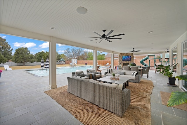 view of patio featuring an outdoor living space, a fenced in pool, fence, and ceiling fan