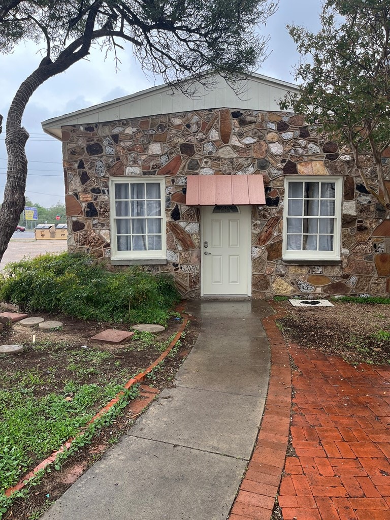 entrance to property with stone siding