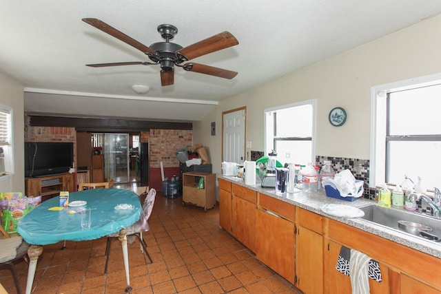 kitchen featuring sink, plenty of natural light, lofted ceiling, and ceiling fan