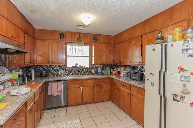 kitchen with sink, stainless steel dishwasher, light tile patterned floors, tasteful backsplash, and white fridge