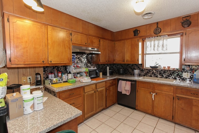 kitchen featuring backsplash, a textured ceiling, sink, light tile patterned floors, and dishwasher