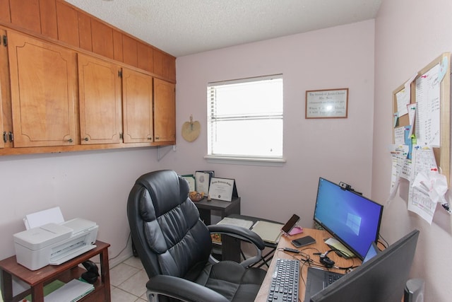 tiled office space featuring a textured ceiling