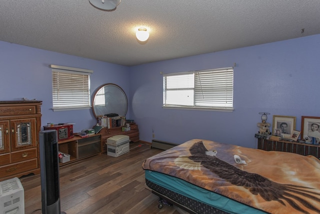 bedroom featuring a textured ceiling, a baseboard radiator, and dark wood-type flooring