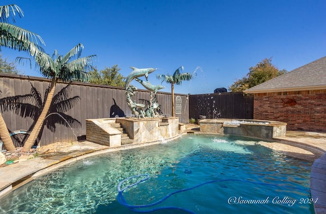 view of pool with pool water feature and an in ground hot tub