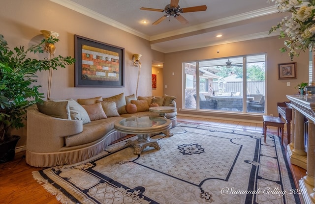 living room featuring crown molding, ceiling fan, and hardwood / wood-style flooring