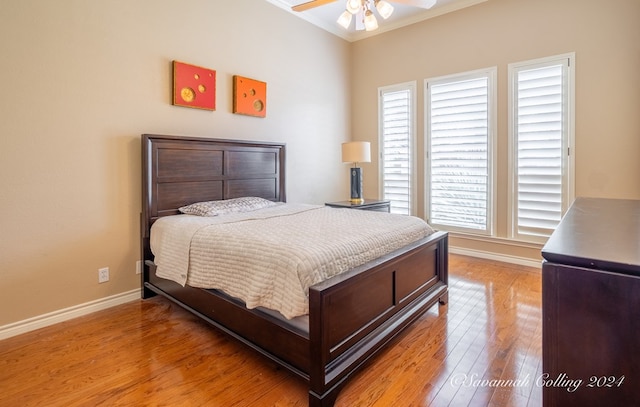 bedroom with hardwood / wood-style floors, ceiling fan, and ornamental molding