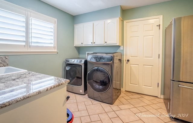 laundry room with separate washer and dryer, sink, light tile patterned floors, and cabinets