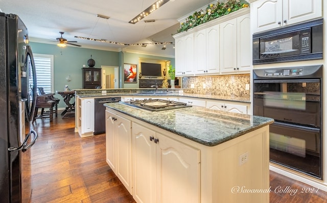 kitchen featuring kitchen peninsula, dark hardwood / wood-style flooring, ceiling fan, black appliances, and a kitchen island