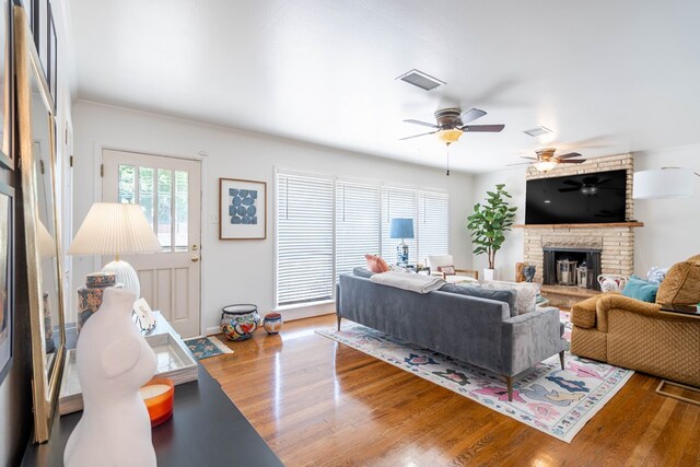 2209 Shell Ave, Midland, TX 79705 - living area featuring a fireplace, wood finished floors, ceiling fan, baseboards, and crown molding