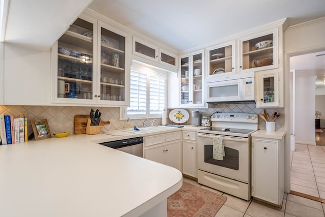 2209 Shell Ave, Midland, TX 79705 - kitchen with white appliances, light tile patterned floors, backsplash, and light countertops