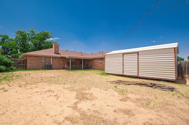 4003 Angelina Dr, Midland, TX 79705 - rear view of property with a chimney, brick siding, and central air condition unit