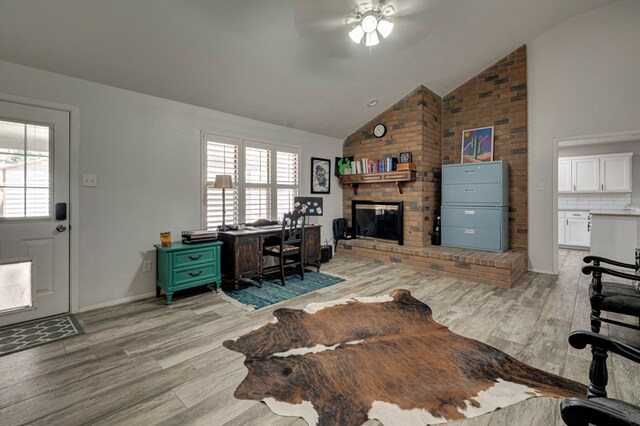 4003 Angelina Dr, Midland, TX 79705 - home office with a ceiling fan, light wood-type flooring, a brick fireplace, and high vaulted ceiling