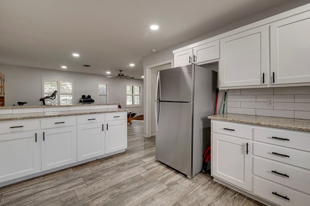 4003 Angelina Dr, Midland, TX 79705 - kitchen with freestanding refrigerator, a ceiling fan, recessed lighting, light wood finished floors, and white cabinetry