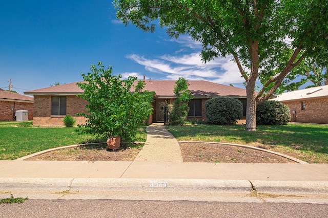 4003 Angelina Dr, Midland, TX 79705 - ranch-style house featuring a front lawn, brick siding, and a shingled roof