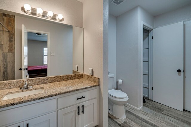 4003 Angelina Dr, Midland, TX 79705 - ensuite bathroom with wood finished floors, vanity, toilet, and a shower