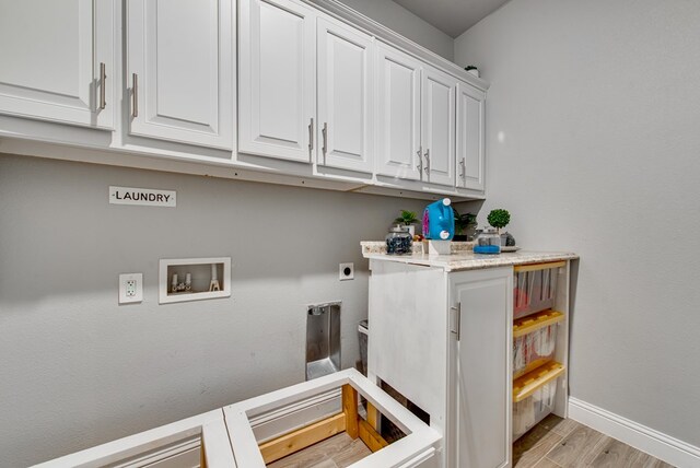 clothes washing area with washer hookup, baseboards, hookup for an electric dryer, light wood-style floors, and cabinet space