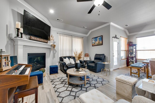 13 La Cresta Ave, Odessa, TX 79765 - living room with crown molding, ceiling fan, baseboards, a brick fireplace, and wood finished floors