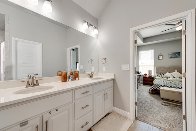 13 La Cresta Ave, Odessa, TX 79765 - ensuite bathroom featuring double vanity, a ceiling fan, lofted ceiling, and baseboards