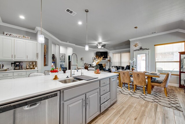 kitchen with visible vents, dishwasher, a sink, light wood-type flooring, and open floor plan