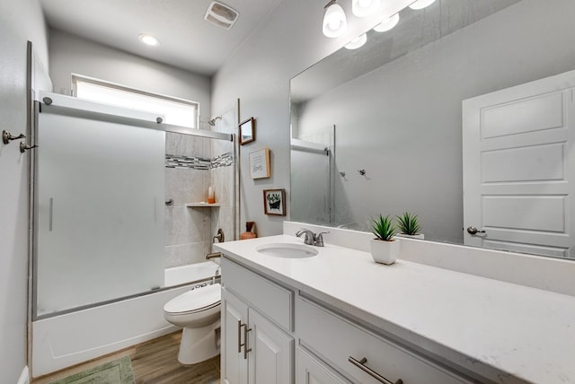 13 La Cresta Ave, Odessa, TX 79765 - full bathroom with toilet, vanity, shower / tub combination, and wood finished floors