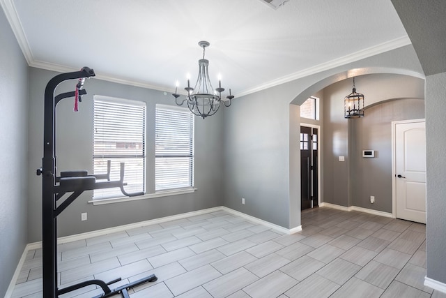 interior space with ornamental molding and a chandelier