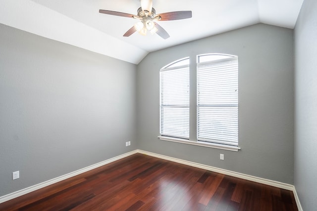 spare room featuring ceiling fan, vaulted ceiling, dark hardwood / wood-style flooring, and a wealth of natural light