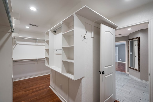 walk in closet with hardwood / wood-style floors