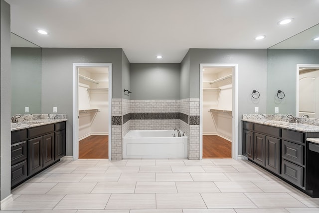 bathroom with a bathing tub and vanity