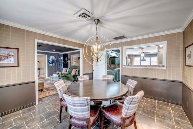 dining space with an inviting chandelier and crown molding