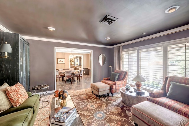 living room with crown molding and a chandelier