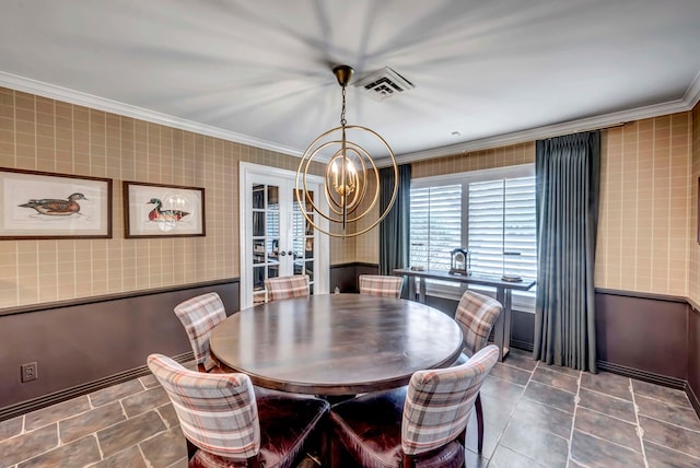 dining room featuring french doors, an inviting chandelier, and ornamental molding