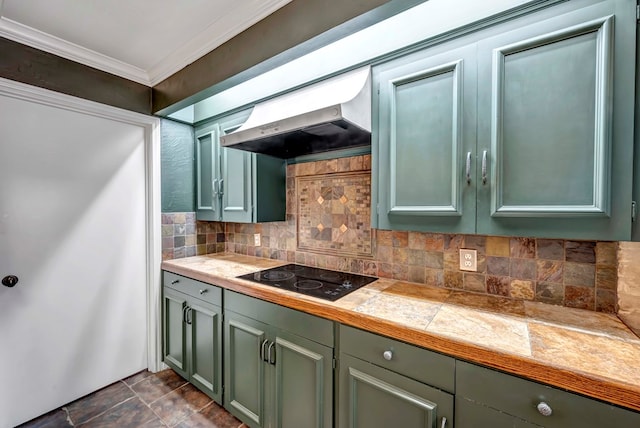 kitchen with black electric cooktop, green cabinets, exhaust hood, and ornamental molding