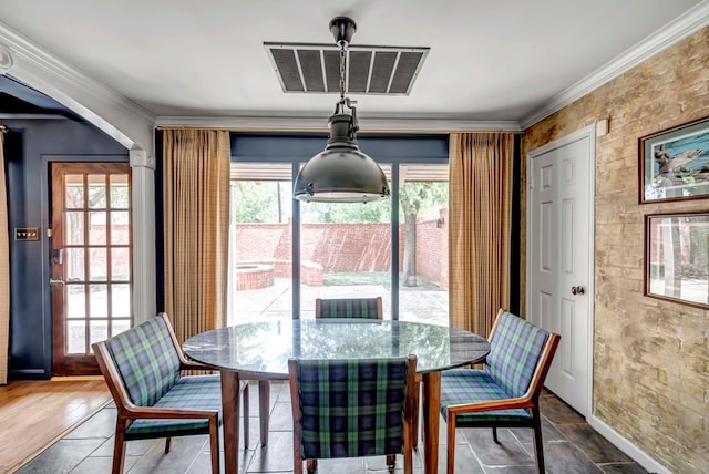 dining area featuring ornamental molding and dark wood-type flooring