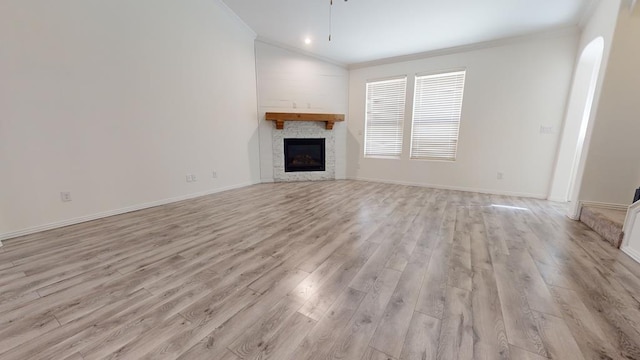 unfurnished living room with crown molding, lofted ceiling, ceiling fan, and light wood-type flooring